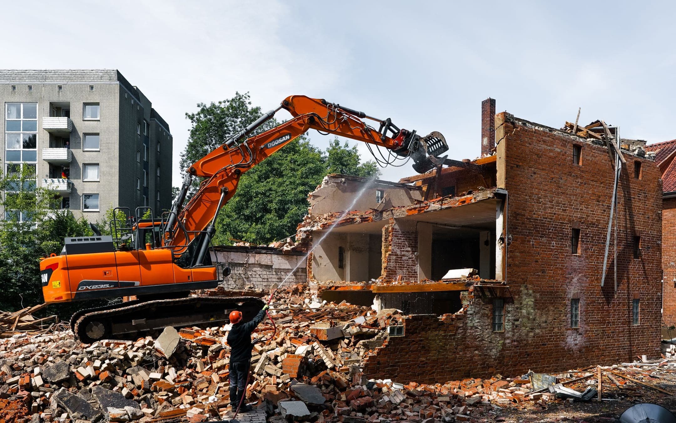 Overhead view of a demolition site with heavy machinery and concrete structures